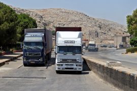 A convoy transporting humanitarian aid crosses into Syria from Turkey through the Bab al-Hawa border crossing on July 8, 2022.