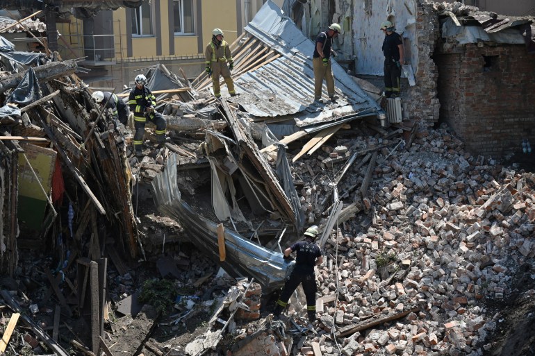 Rescuers inspect residential buildings destroyed by a missile attack in Kharkiv, eastern Ukraine