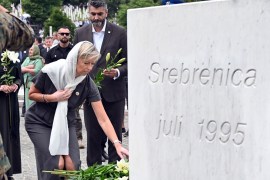 Dutch Defence Minister Kajsa Ollongren pays tribute to the victims of the 1995 Srebrenica massacre, during a mass burial at the memorial cemetery in the village of Potocari, near eastern Bosnian town of Srebrenica, on July 11, 2022 [Elvis Barukcic/AFP]