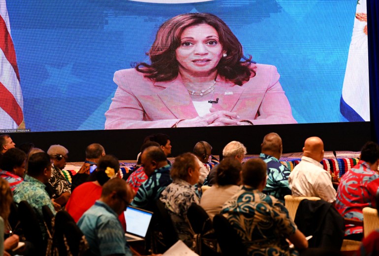 US Vice President Kamala Harris appears on a large video screen speaking to delegates at the Pacific Islands Forum in Suva, Fiji.
