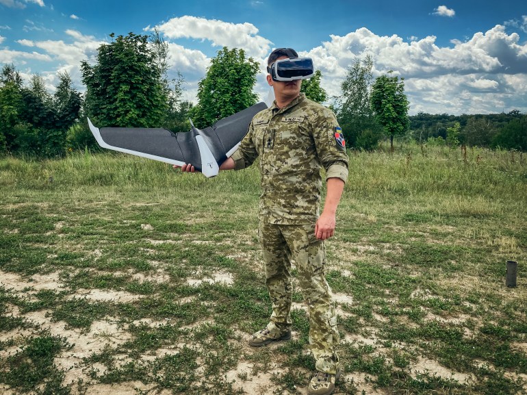 Ukrainian lieutenant Anton Galyashinskiy holds a Parrot drone during a practice session on the outskirts of Kyiv, on July 14, 2022 [Ionut Iordachescu/AFP]