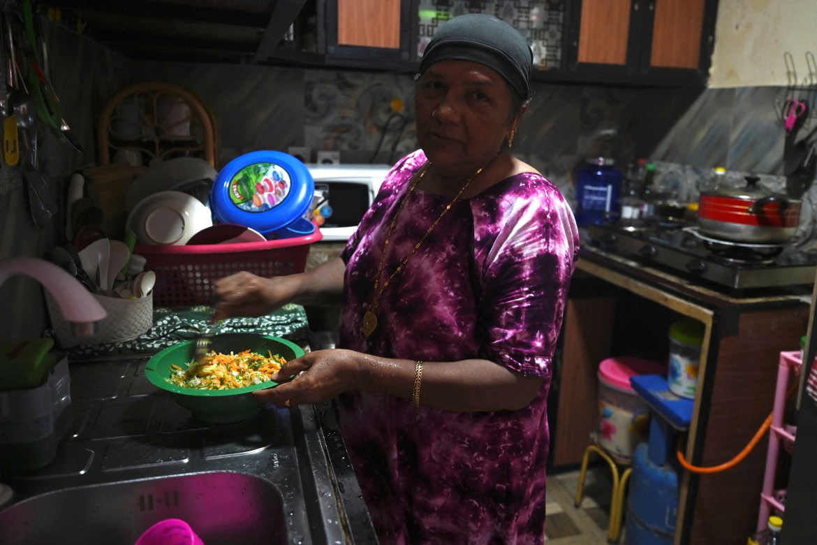 Shahul Zareena working in her kitchen