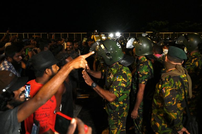 Protesters and soldiers confront each other in the early hours of Friday morning in Colombo