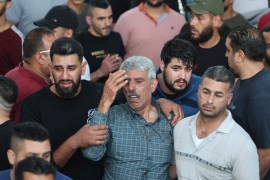 Palestinian relatives of a man killed by Israel stand outside a Nablus hospital