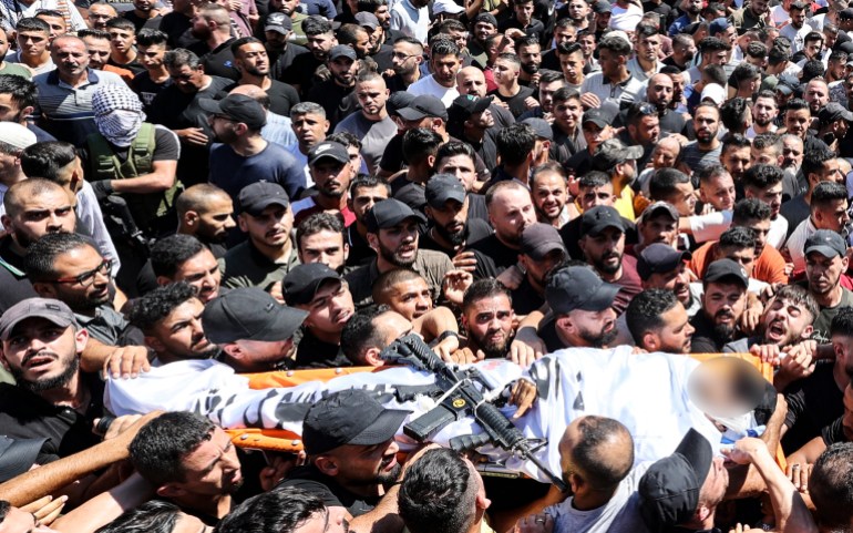 Mourners carry the body of one of two Palestinians killed earlier in an Israeli raid in the old quarter of the West Bank city of Nablus [Jaafar Ashtiye/AFP]