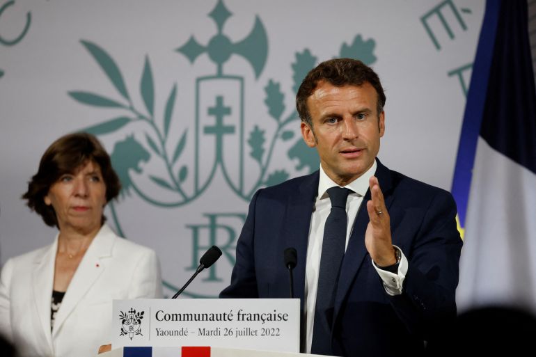 France's President Emmanuel Macron (R) flanked by French Foreign and European Affairs Minister Catherine Colonna delivers a speech to the local French community in Cameroon during a meeting at the French Embassy in Yaounde, on July 26, 2022. - Emmanuel Macron in on a three-day African tour in Cameroon, Benin and Guinea-Bissau.