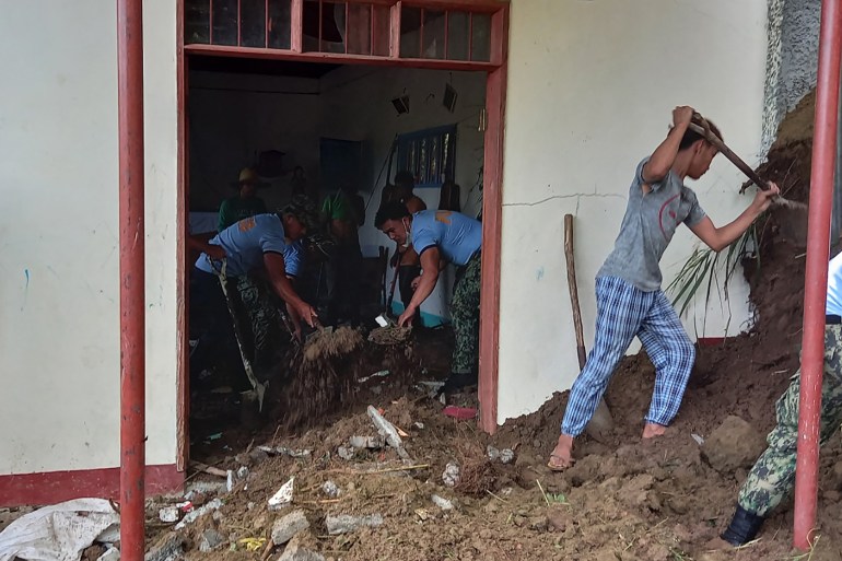 This handout photo released by the Police Regional Office-Cordillera (PROCOR) on July 27, 2022 shows villagers and rescue workers digging at a chapel following a landslide caused by a 7.0-magnitude earthquake in the northern Philippines, in the village of Mayag in Bauko .  (Photo by Handout / POLICE REGIONAL OFFICE-CORDILLERA (PROCOR) / AFP) / -----EDITORS NOTE --- RESTRICTED TO EDITORIAL USE - MANDATORY CREDIT "AFP PHOTO / POLICE REGIONAL OFFICE-CORDILLERA (PROCOR) " - NO MARKETING - NO ADVERTISING CAMPAIGNS - DISTRIBUTED AS A SERVICE TO CLIENTS
