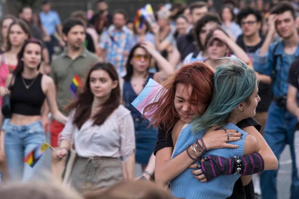 Two girls hugged each other during the Pride March