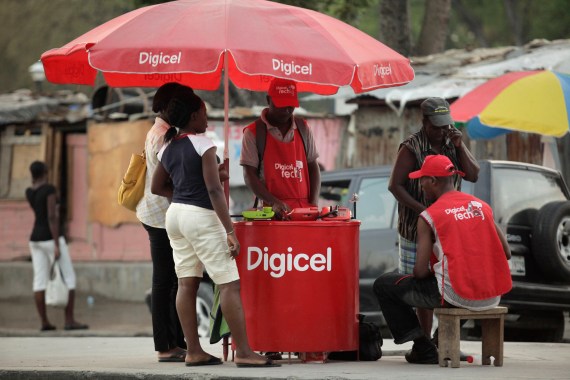 People use Digicel wireless phones in downtown Port-au-Prince, Haiti