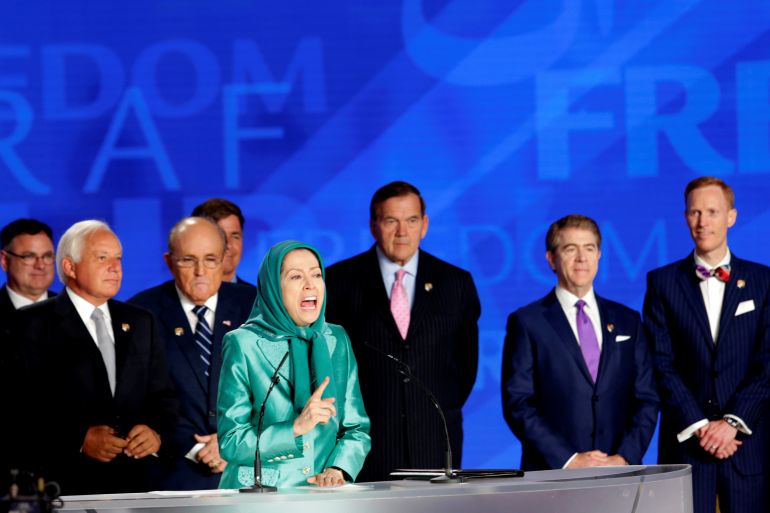 Maryam Rajavi, the President-elect of the National Council of Resistance of Iran, speaks while US officials stand behind her