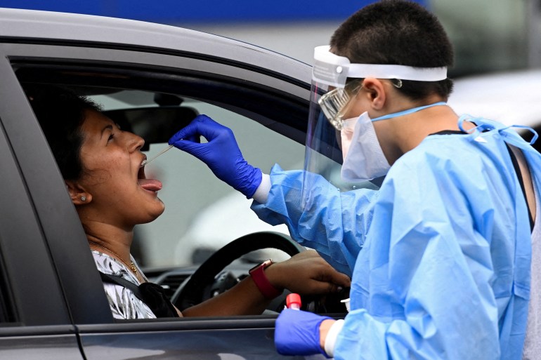 A woman is tested for COVID-19 at a drive-thru testing site in Sydney, Australia.