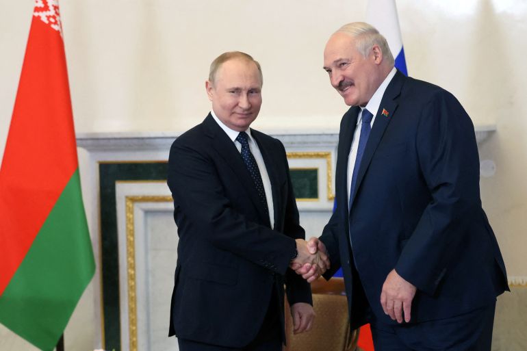 Russian President Vladimir Putin shakes hands with his Belarusian counterpart Alexander Lukashenko.