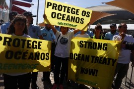 Greenpeace activists hold banners saying: &#39;Protect the Oceans&#39; during a demonstration outside the UN Ocean Conference in Lisbon, Portugal [Pedro Nunes/Reuters]