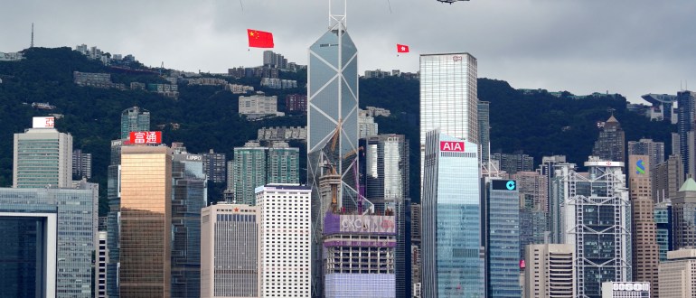 Helicopters carrying Chinese and Hong Kong flags fly over the Victoria Harbour during a flag-raising ceremony at the Golden Bauhinia Square, on the 25th anniversary of the former British colony’s handover to Chinese rule, in Hong Kong, China July 1, 2022. cnsphoto via REUTERS   ATTENTION EDITORS – THIS IMAGE WAS PROVIDED BY A THIRD PARTY. CHINA OUT.      TPX IMAGES OF THE DAY