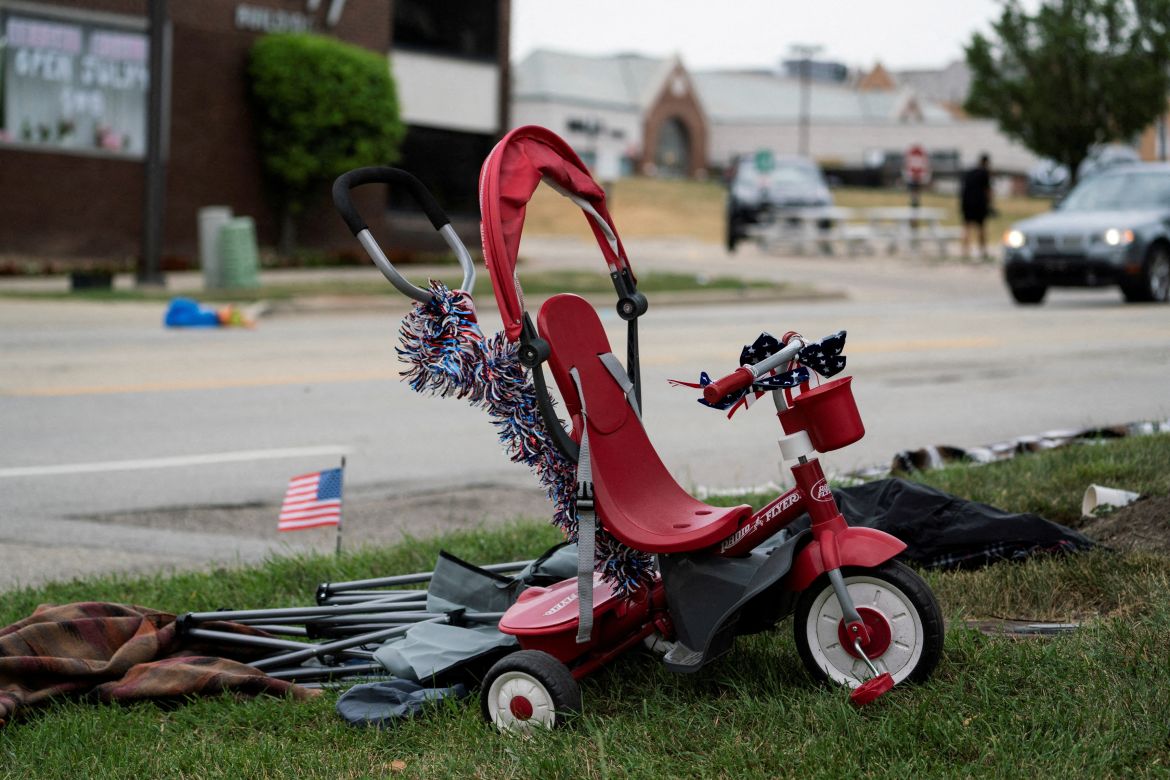 A tricycle is seen near the scene of a mass shooting at a Fourth of July parade