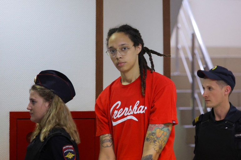 US basketball player Brittney Griner is escorted by police before a court hearing in Khimki, outside Moscow, Russia, in July.