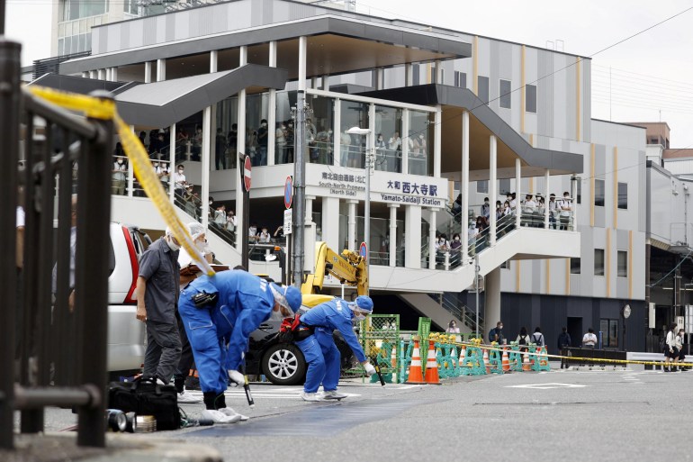 Investigators work around the scene where former Japanese Prime Minister Shinzo Abe was shot