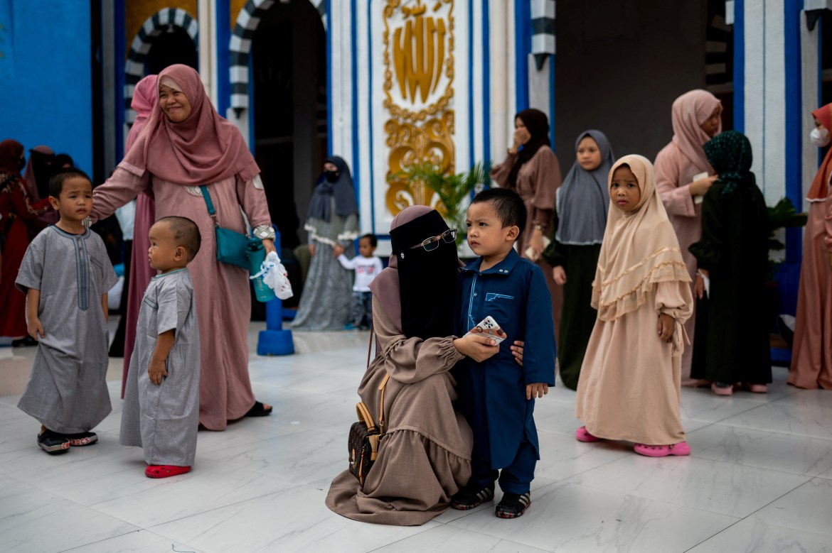 Filipino Muslims gather outside the Blue Mosque after the morning prayer on Eid al-Adha, in Taguig City, Metro Manila, Philippines