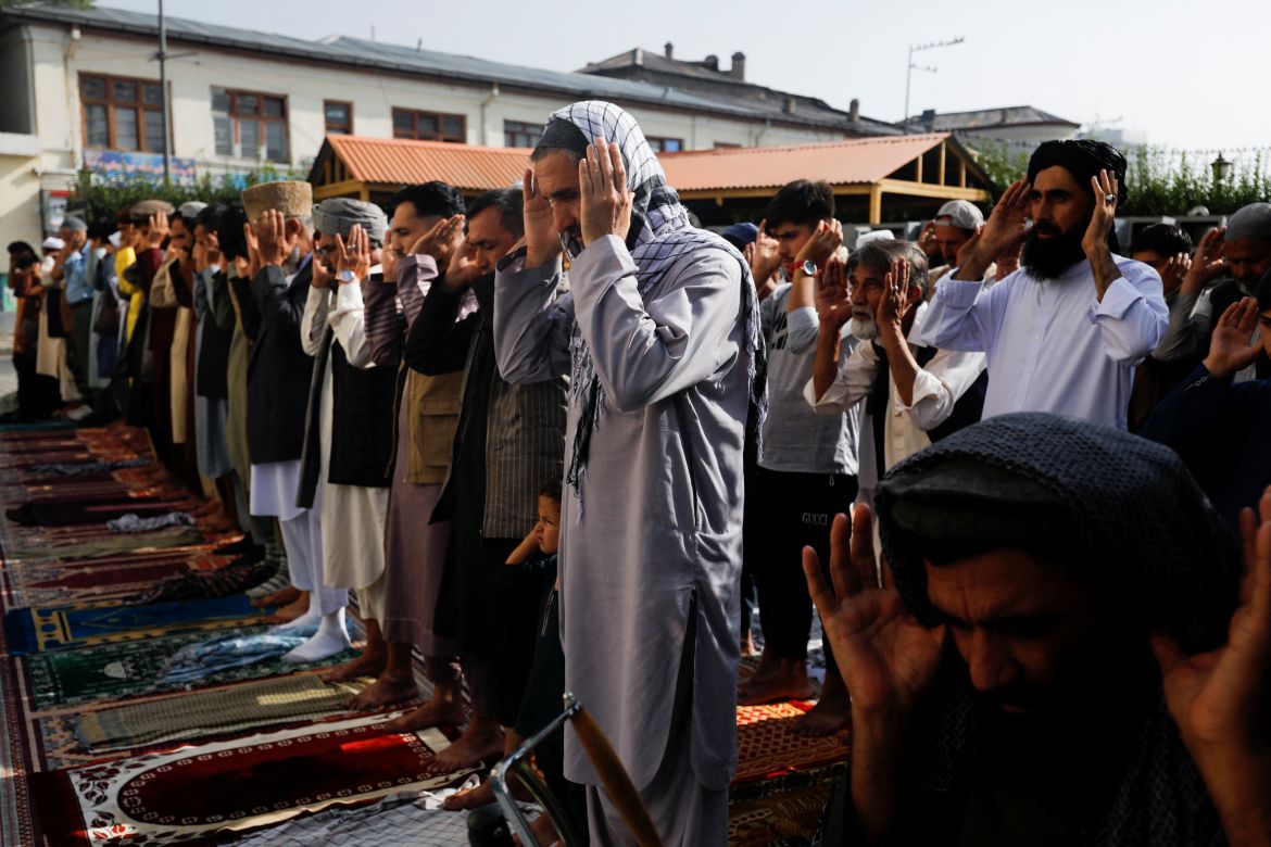 Afghan people pray on the first day of Eid al-Adha, in Kabul