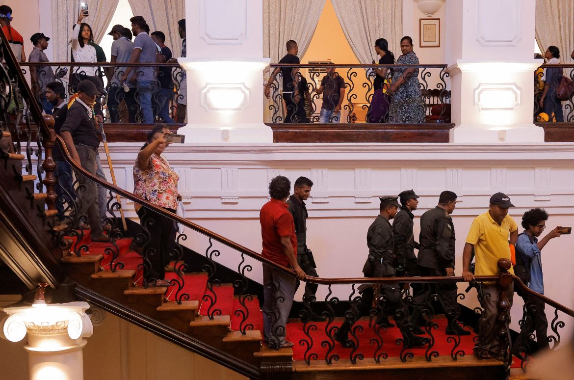 Sri Lankan army members leave after demonstrators entered into the President's House,