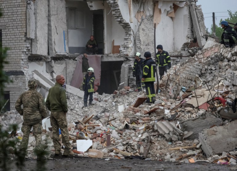 Rescuers work at a residential building damaged by a Russian military strike in the town of Chasiv Yar, in Donetsk region, Ukraine, July 11, 2022 