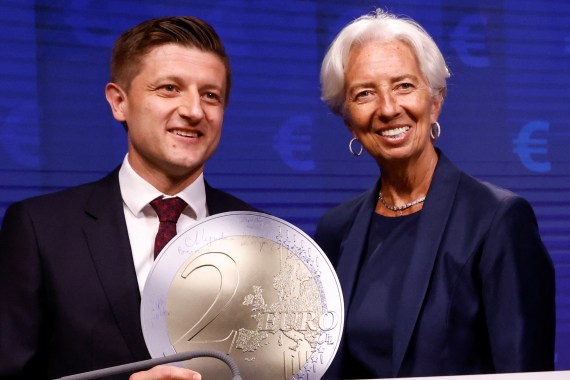 Croatia's Finance Minister Marko Primorac and President of European Central Bank Christine Lagarde pose with a model of a Euro coin