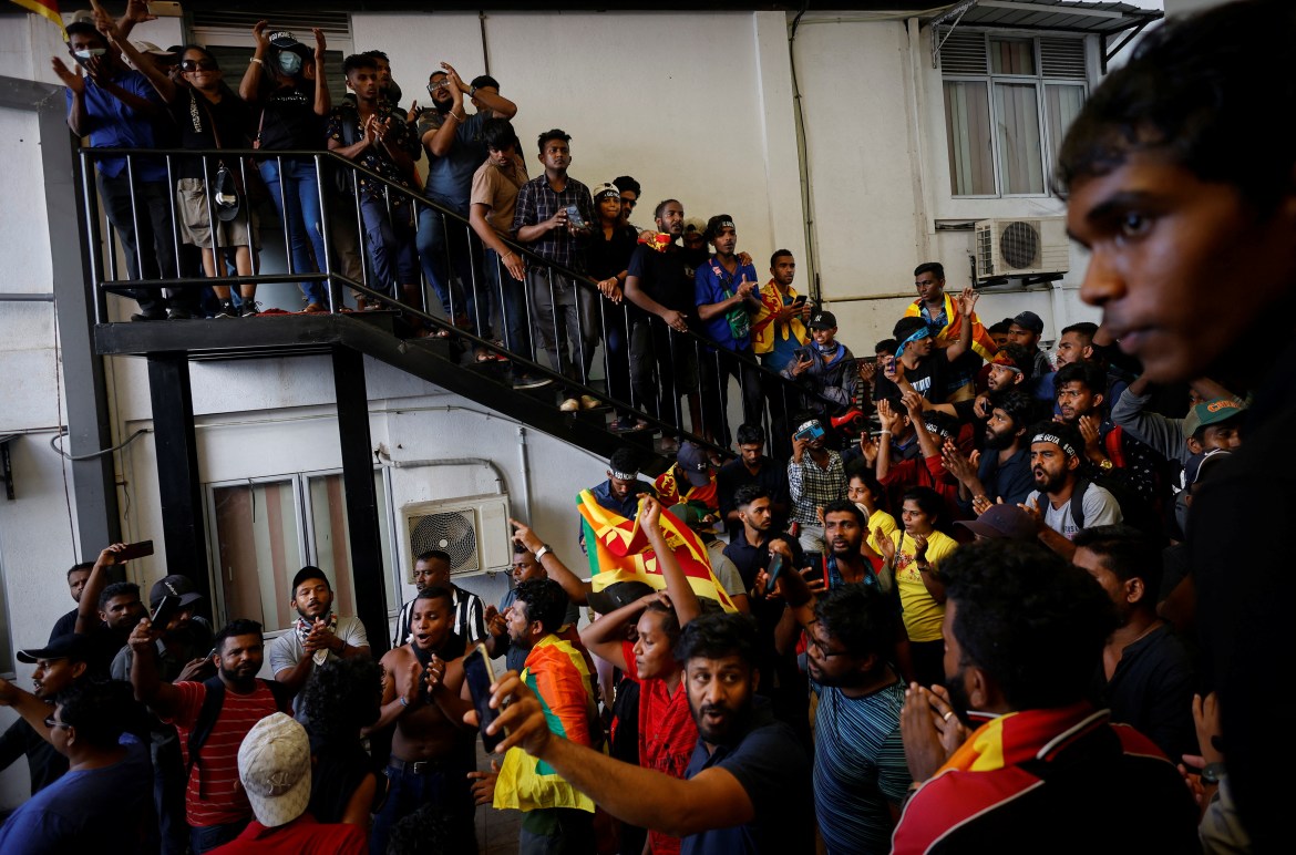 Protestors celebrate after entering the Sri Lanka's Prime Minister Ranil Wickremesinghe's office premises