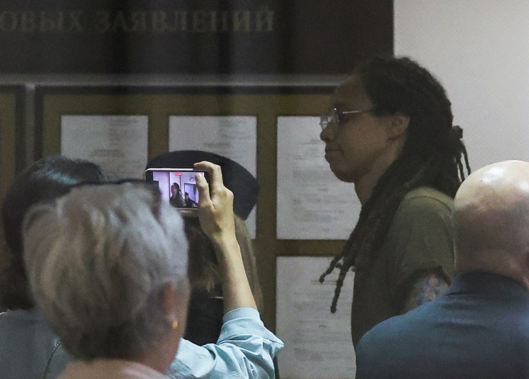 Brittney Griner is escorted to a court hearing in Russia