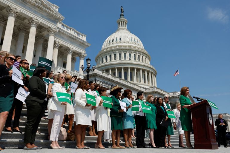 Nancy Pelosi and other House Democrats stand outside Congress during a news conference on abortion rights