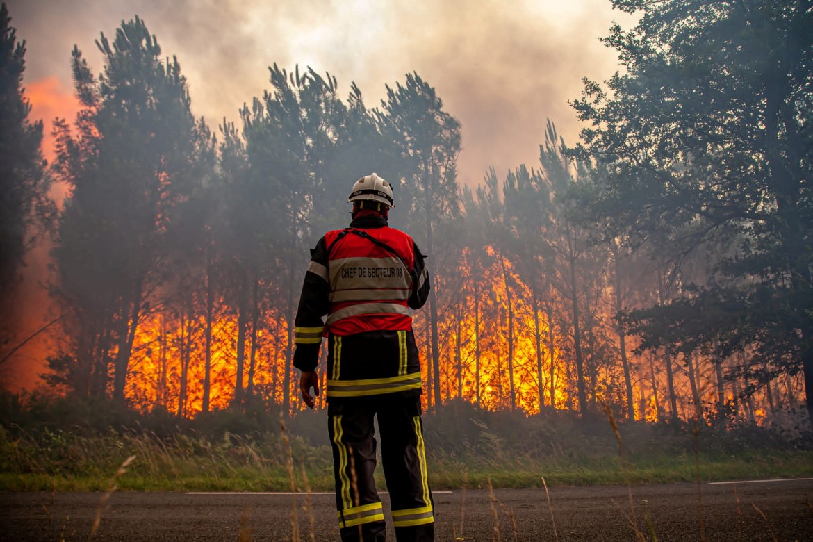 A firefighter works to contain a fire that broke out near Landiras, as wildfires continue to spread in the Gironde region of southwestern France