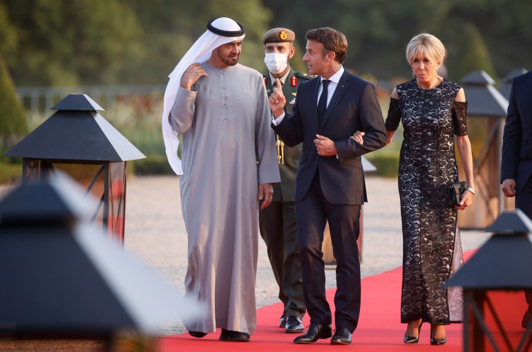 French President Emmanuel Macron, United Arab Emirates' President Sheikh Mohammed Bin Zayed and French first lady Brigitte Macron arrive to a state dinner, at the Grand Trianon in Versailles, in Paris