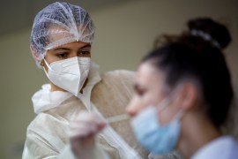 A medical worker administers a nasal swab to a patient at a COVID testing centre in Les Sorinieres, near Nantes, France.