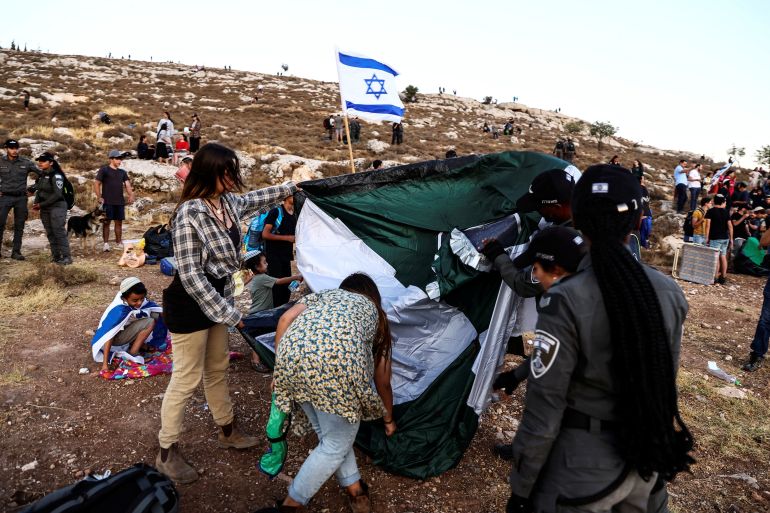 Israelis Border police evacuate Israelis and their tent during a gathering of the Israeli settlement movement making a bid to set a new settlement close to Kiryat Arba, a Jewish settlement in Hebron in the Israeli-occupied West Bank July 20, 2022.