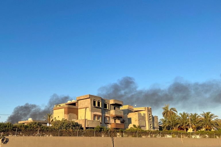 Smoke rises above buildings in Tripoli