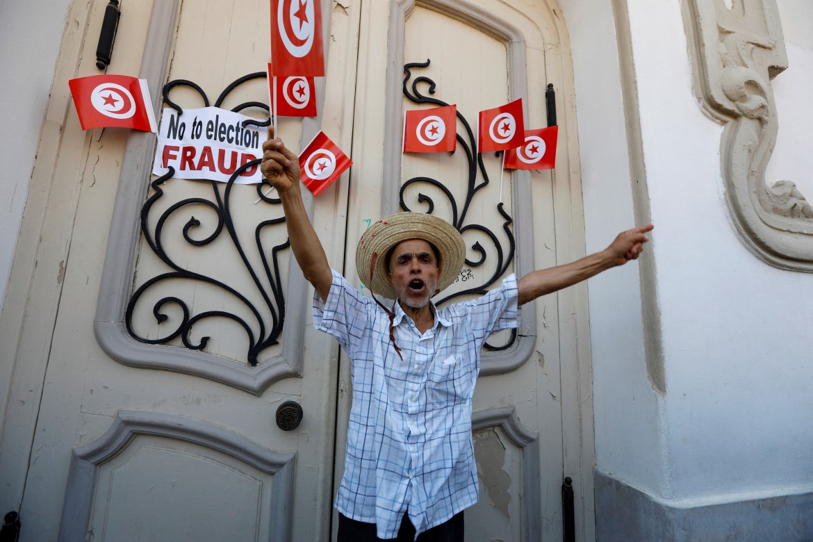A demonstrator takes part in a protest against President Kais Saied