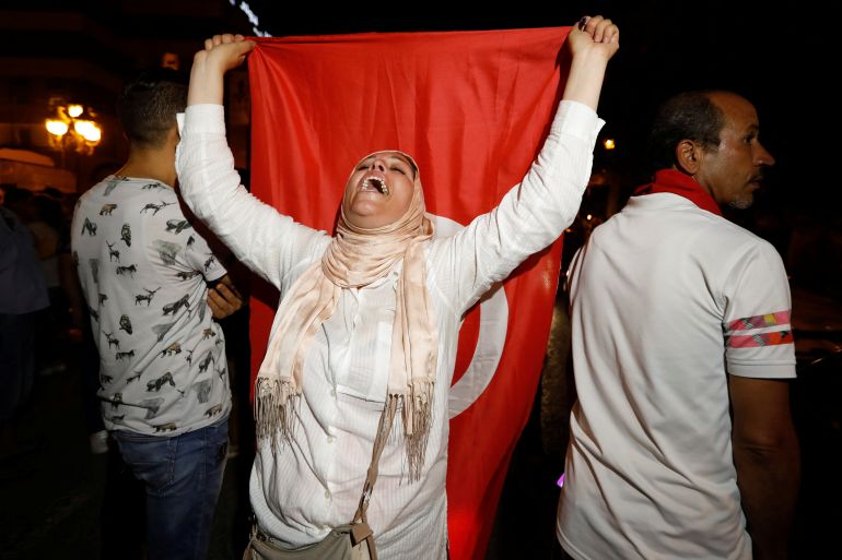 Woman holds Tunisian flag