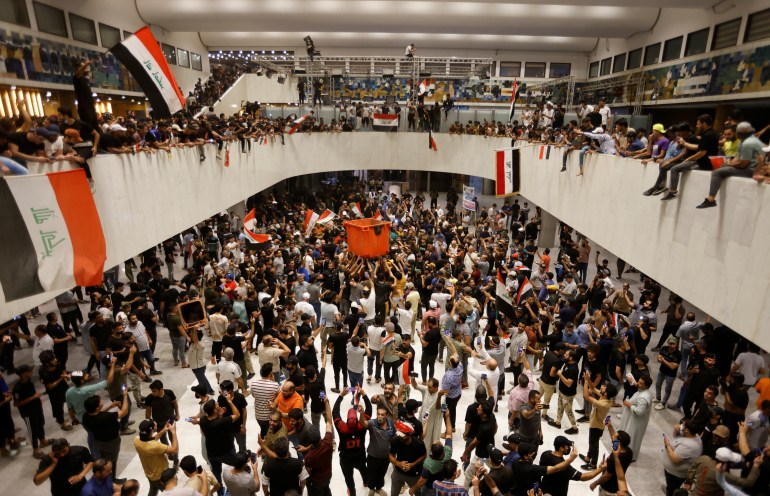 Supporters of Iraqi Shi'ite cleric Moqtada al-Sadr protest against corruption inside the parliament building in Baghdad,
