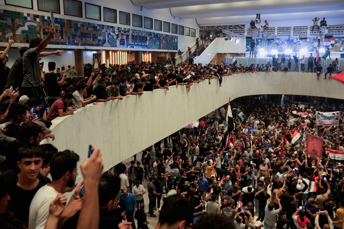 Supporters of Iraqi Shi'ite cleric Moqtada al-Sadr protest against corruption inside the parliament building