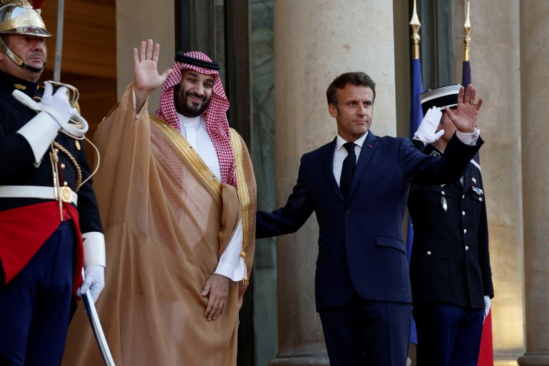 French President Emmanuel Macron and Saudi Crown Prince Mohammed bin Salman gesture ahead of a working dinner at the Elysee Palace in Paris.