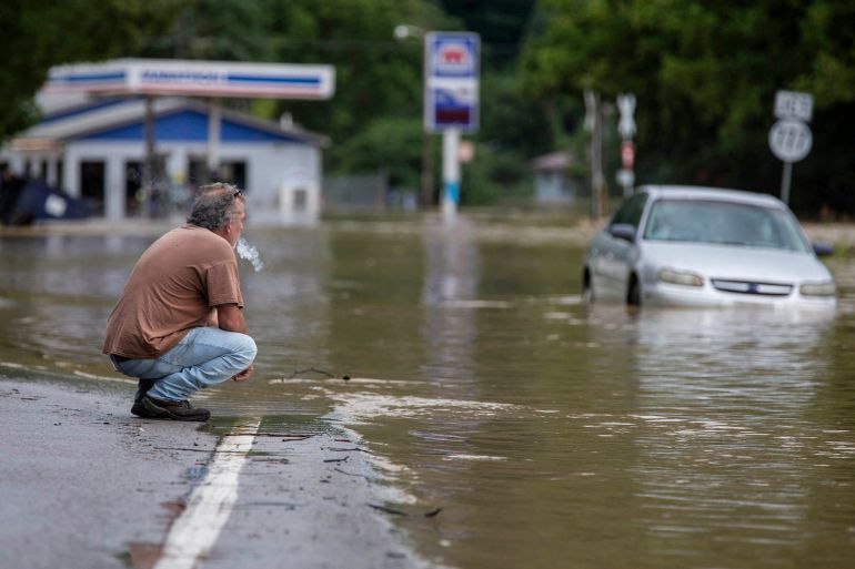 A man looks out at flood waters in Kentucky, US