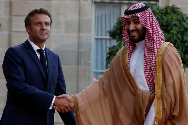 French President Emmanuel Macron and Saudi Crown Prince Mohammed bin Salman shake hands at the Elysee Palace in Paris.