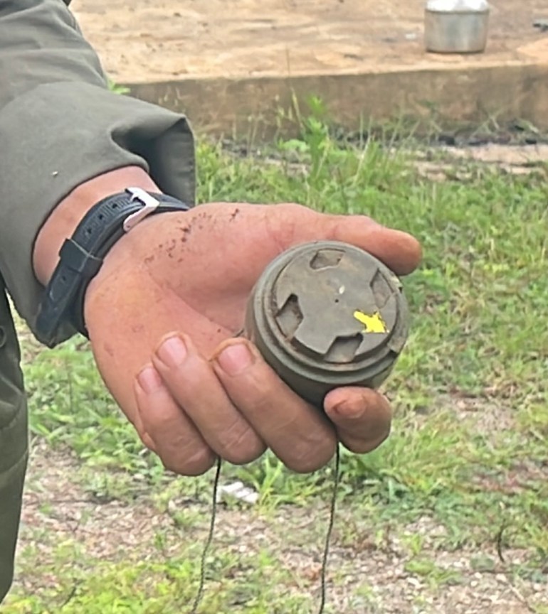 A person holds an M-14 landmine after it was removed from the compound of a church in Kayah state.