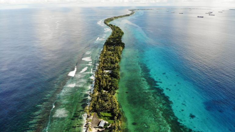 A strip of land between the Pacific Ocean and a lagoon in Funafuti, Tuvalu.