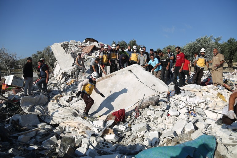 Rescue workers dig through the rubble of a house hit in an airstrike