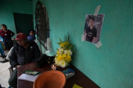 A photo of Pascual Melvin Guachia hangs over a small altar in the family's home in Guatemala