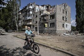 A man passes by a damaged building as Russia-Ukraine war continues in Mykolaiv, Ukraine.