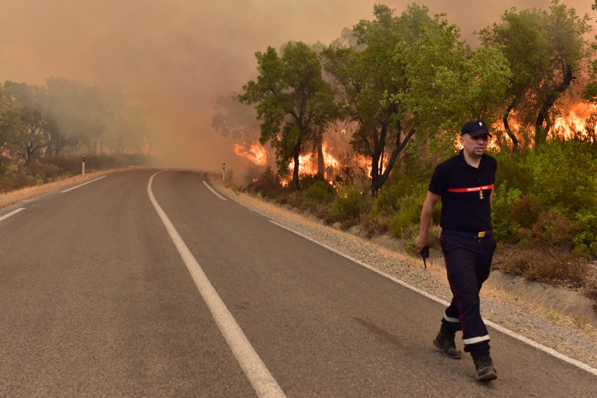 Firefighters intervene by land to control a wildfire in Rabat