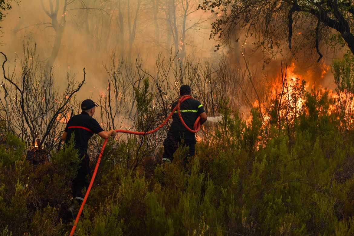 Firefighters intervene by land to control a wildfire in Rabat