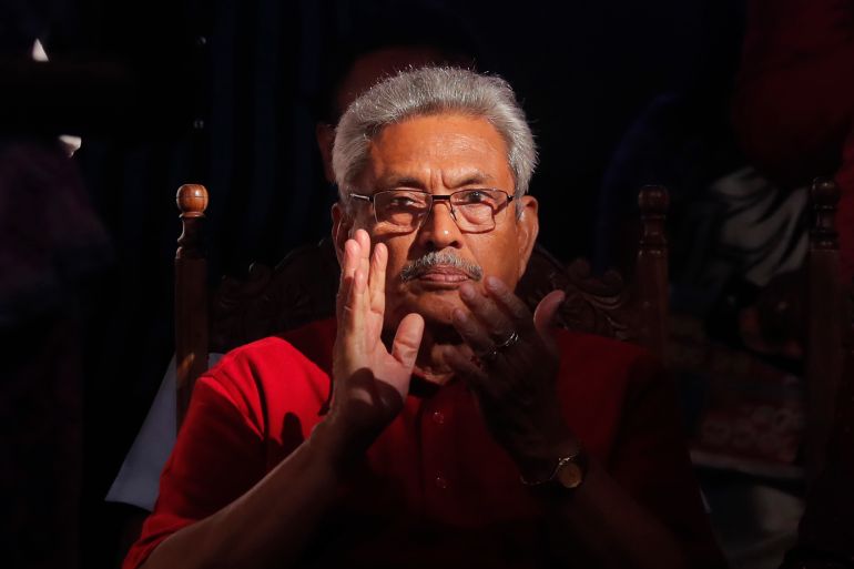 Gotabaya Rajapaksa against a black background looking serious