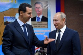 Syrian President Bashar Assad, left, gestures while speaking to Russian President Vladimir Putin.